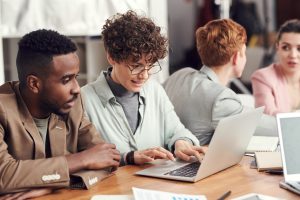 two people looking at laptop